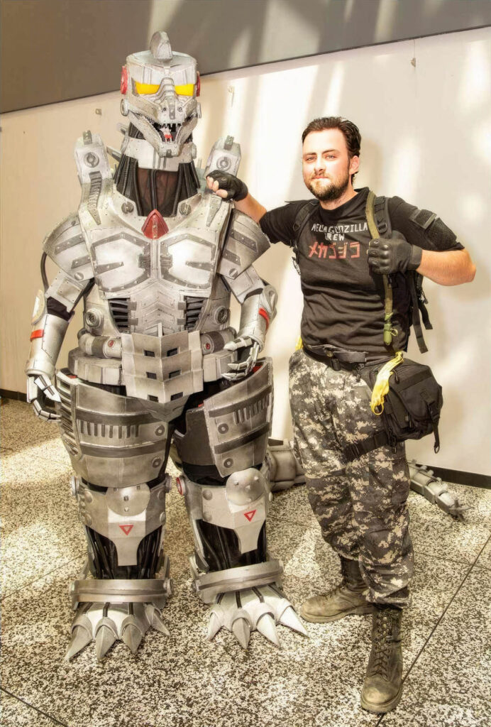 Jonathan Le Guedar standing next to his Mechagodzilla