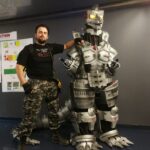 Jonathan Le Guedar standing next to his Mechagodzilla suit